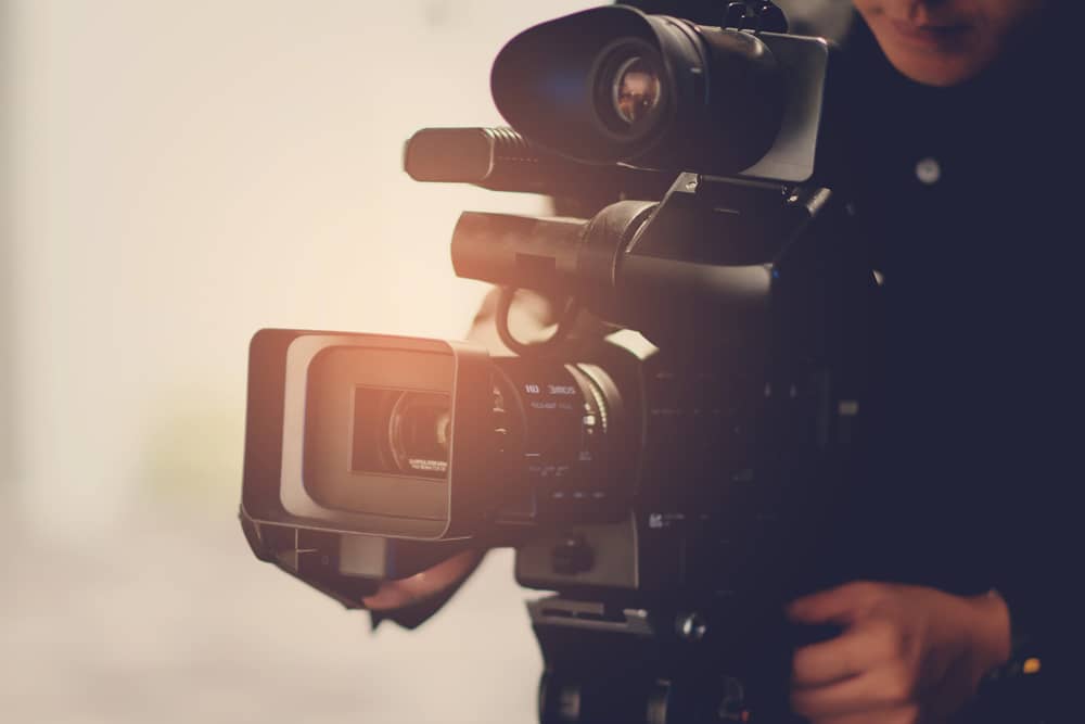 person using a professional video camera